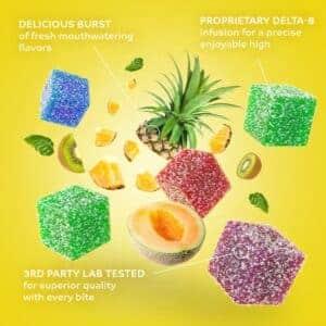 Assorted tropical fruit Delta-8 gummies with melon, pineapple, and kiwi on a yellow background