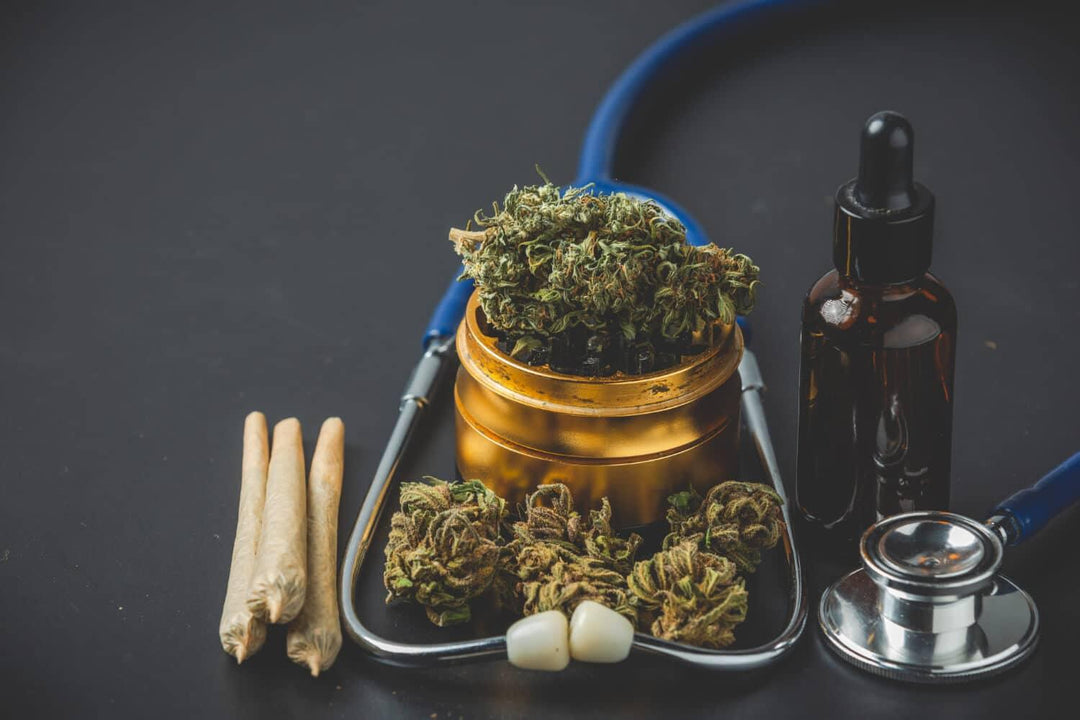 Medical cannabis buds, joints, oil dropper bottle and stethoscope on black background